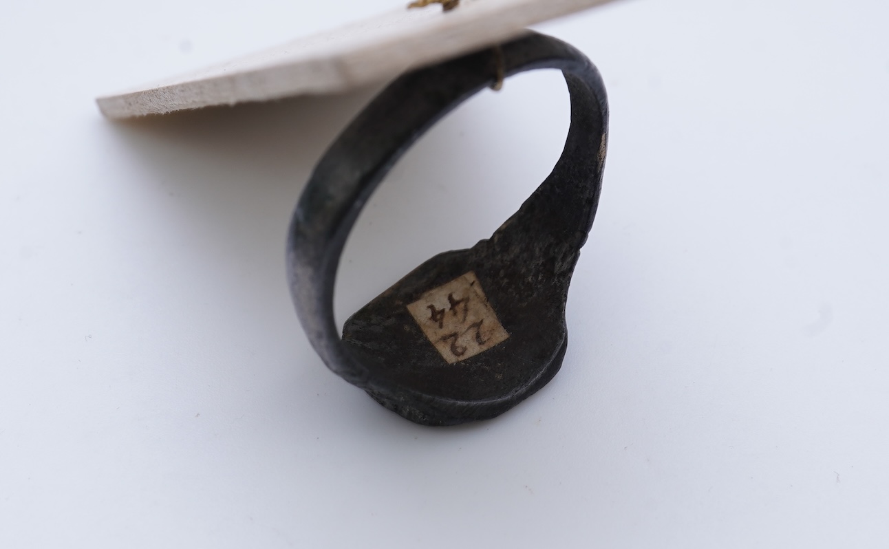 A sentimental signet ring, France, circa 16th century, the circular panel depicting two hearts tied in a true lover's knot, size R1/2, labelled 2244, Provenance: formerly in the collection of Dame Joan Evans (1893-1977)